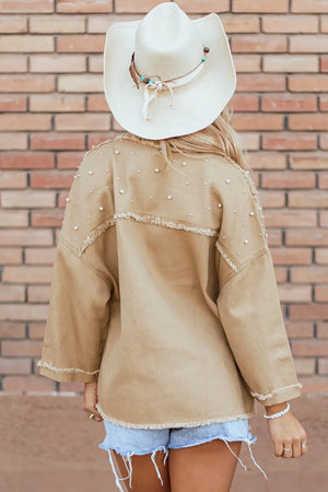Tan utility jacket with pearl embellishments and raw edges.