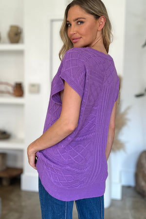 Purple knit patchwork top with short sleeves and a textured cable pattern.