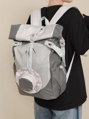 Sleek roll-top nylon backpack in light gray with buckle closures and a front zip pocket.