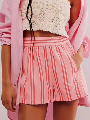 Pink striped shorts with elastic waistband and pockets, styled with a crochet top.
