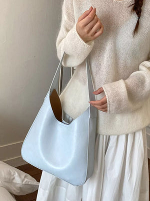Sleek large blue pu leather shoulder bag with a slouchy silhouette.