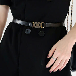 Black vegan leather belt with interlocking gold buckle detail.