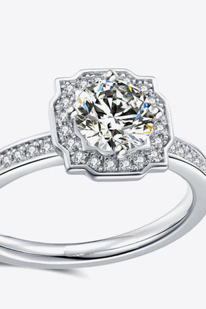 Silver halo diamond engagement ring with pavé band.