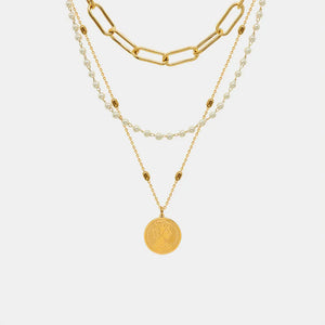 Gold layered necklace with chunky chain, pearls, and coin pendant