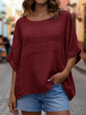 Wine red relaxed fit blouse with horizontal seam details and short sleeves.