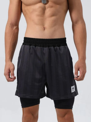Layered mesh performance shorts in dark gray with black compression liner and vertical stripe pattern.