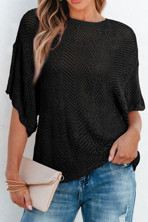 Black open-knit chevron sleeve top with a relaxed fit, styled with jeans and a clutch.