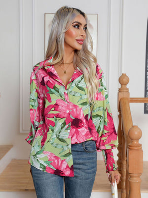 Blouson sleeve button-up shirt with a vibrant floral print in hot pink and green.