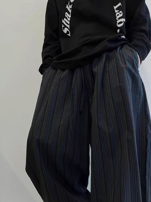 Men's wide leg sweatpants in dark blue with subtle pinstripes and pockets.