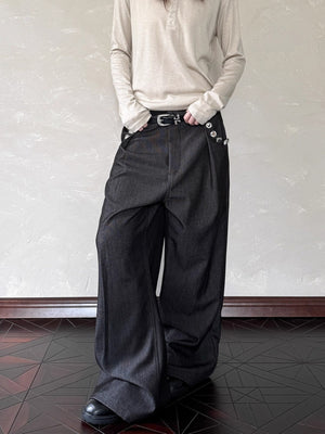 Men's black wide leg sweatpants with decorative buttons and a belt.