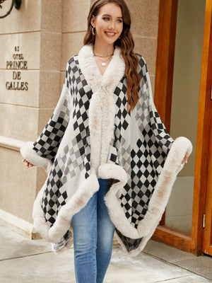 Diamond checkered poncho with faux fur trim in ivory and charcoal.