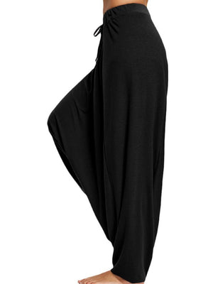 Black drape-front drawstring harem pants with a relaxed fit