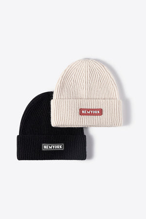 Ribbed acrylic beanies in black and beige, each with a "New York" patch detail.