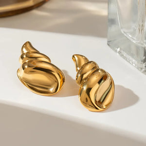 Gold sculptural seashell drop earrings with a polished finish.