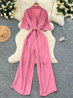 Pink belted wide-leg maternity jumpsuit with pockets and short sleeves