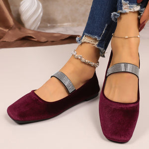 Elegant square toe slip-on flats in velvet with rhinestone strap detail.