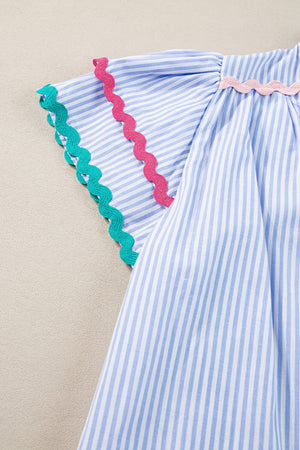 Light blue and white striped blouse with scalloped trim on sleeves and neckline.