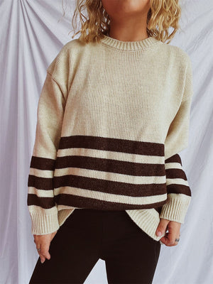 Ribbed knit sweater in tan with dark gray horizontal stripes, crew neck, long sleeves.