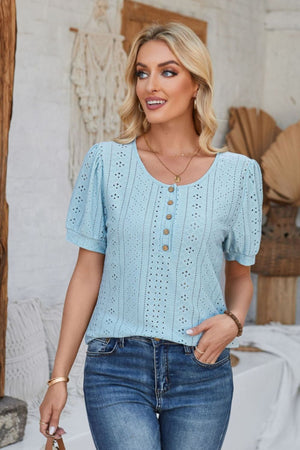 Light blue perforated puff sleeve henley blouse with button detail and eyelet pattern.