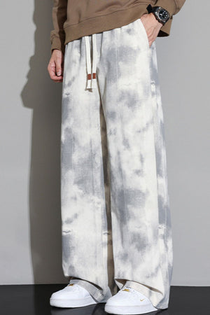 Relaxed fit sweatpants in off-white with a grey cloud pattern and drawstring waist.