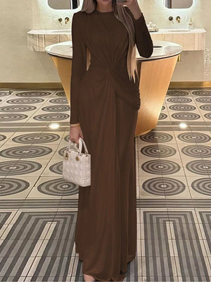 Brown ruched long sleeve maxi dress with a twist detail and boat neckline.
