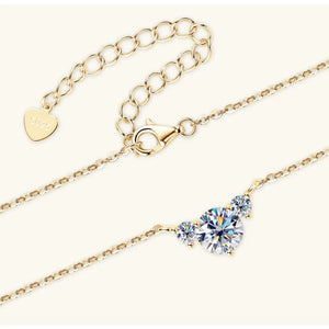 Gold necklace with a celestial trio of sparkling diamonds and a heart-shaped tag.