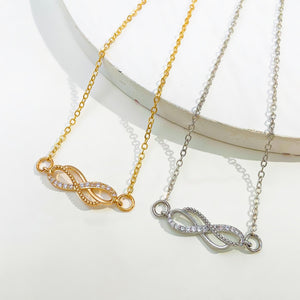 Gold and silver infinity knot charm bracelets with cubic zirconia details
