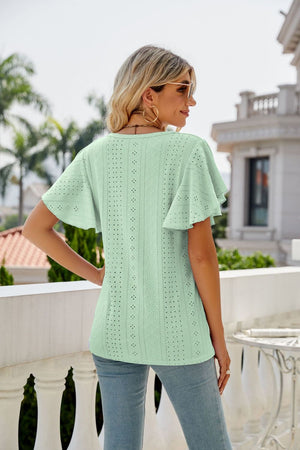 Light green eyelet flounce sleeve crew neck top with allover perforations.
