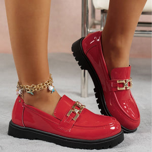 Red patent chunky loafers with gold buckle detail and charm anklet.
