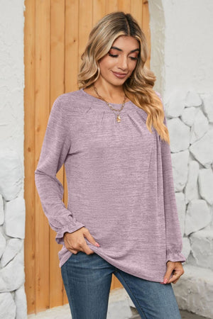 Lilac knit top with pleated yoke and ruffled cuffs, long sleeves, crew neck.