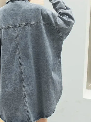 Oversized denim trucker jacket in medium wash with visible seams and relaxed fit.