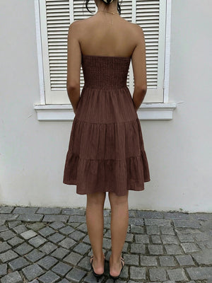 Dark brown strapless mini dress with gathered bodice and tiered ruffles.