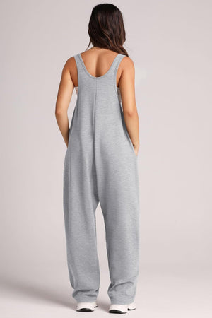 Relaxed fit pocketed tank jumpsuit in light gray with wide legs and side pockets.