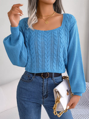 Azure cable knit sweater with square neckline and balloon sleeves.