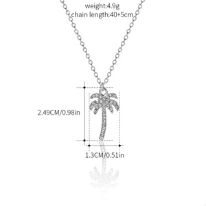 Silver palm tree pendant necklace with clear rhinestones on a delicate chain.