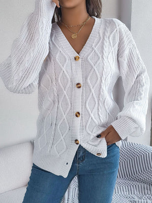 White cable knit cardigan with balloon sleeves and button front.