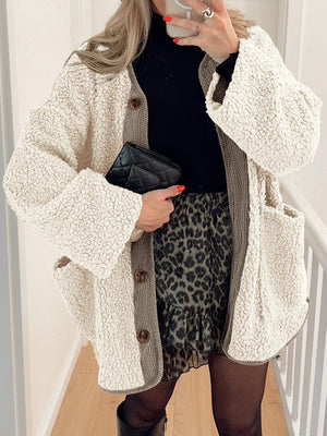 Cream teddy-texture button-up jacket with corduroy trim and pockets.