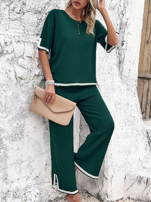 Dark green knit co-ord set with contrast trim on sleeves and pants.