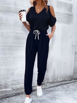 Dark blue cold-shoulder jumpsuit with drawstring waist and v-neckline