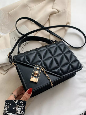 Black diamond quilted PU leather crossbody bag with gold hardware and chain detail.