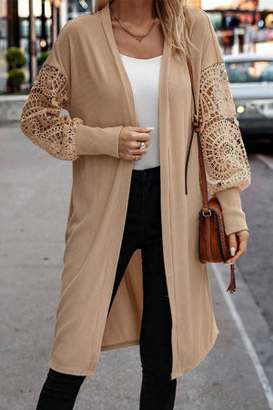 Tan ribbed knit duster cardigan with intricate lace sleeves and open front.