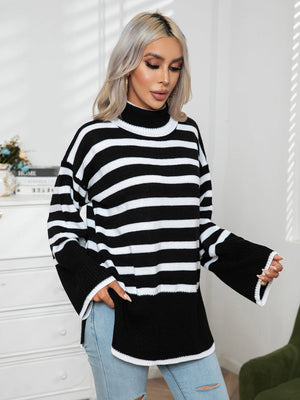 Black and white striped turtleneck sweater with flared sleeves and acrylic knit.