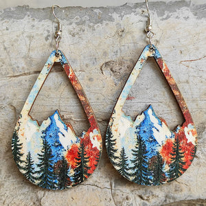 Teardrop silhouette earrings with mountain and forest scene, boho style.