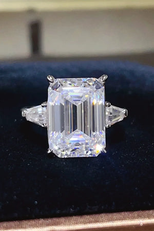 Silver ring with emerald cut moissanite and trillion side stones