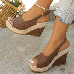 Brown woven espadrille wedge sandals with peep toe and slingback strap.