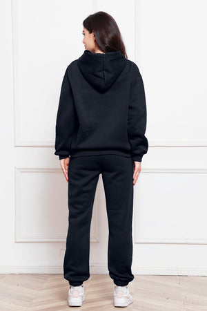 Black relaxed fit hoodie and joggers loungewear set with cuffed ankles.