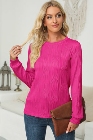 Textured wave crewneck pullover in cerise with long sleeves.