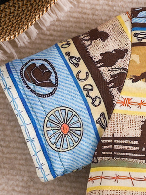 Children's western print tee with cowboy hat, wagon wheel, horses, and fence details.