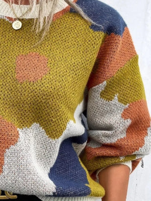 Abstract floral knit sweater with round neck in olive, blue, orange, and pink colorblock pattern.