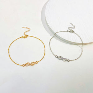 Gold and silver infinity knot charm bracelets with adjustable chains